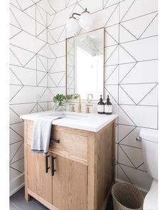 a bathroom vanity with a mirror, sink and towel on the counter in front of it