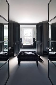 a bedroom with mirrored walls and black furniture