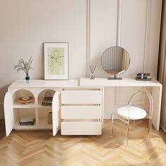 a white desk with two chairs and a mirror on it in a room that has wood floors