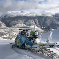 a snowmobile sitting on top of a snowy mountain