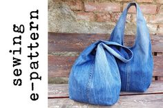 a denim purse sitting on top of a wooden bench