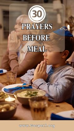 a young boy sitting at a table with his hands clasped to his face while praying