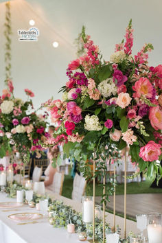 a long table with flowers and candles on it