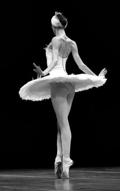 a ballerina in white tutu and ballet shoes