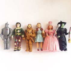 a group of toy figurines sitting next to each other on a white surface