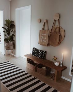 a living room filled with lots of furniture next to a wall mounted bag on the wall