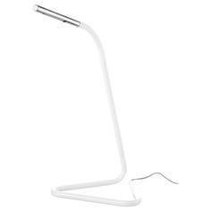 a white desk lamp sitting on top of a table