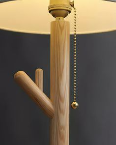 a lamp that is made out of wood and has a chain hanging from it's end