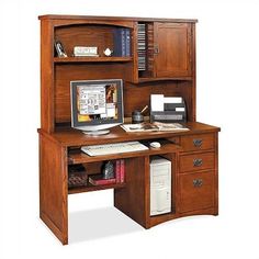 a computer desk with a hutch on top of it and a keyboard in the middle