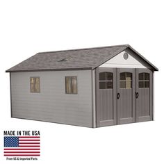 a gray shed with two windows and a flag on the outside wall next to it