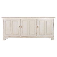 a white cabinet with three doors and two drawers on one side, in front of a white background