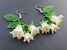 beaded earrings with white flowers and green leaves