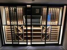 an empty wine cellar is seen through the glass doors