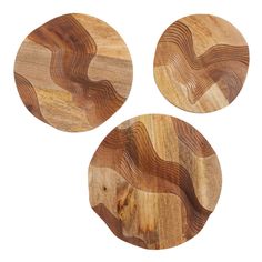 three wooden coasters with wavy designs on the top one is round and two are circular