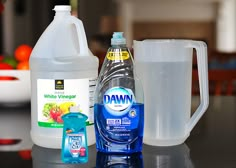 a bottle of water and a container of liquid on a table