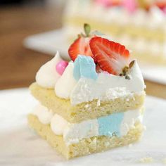 a piece of cake with white frosting and strawberries on top