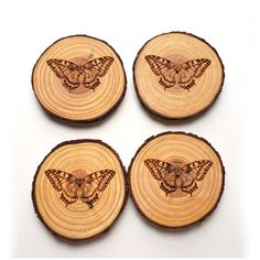 four wooden coasters with butterflies on them