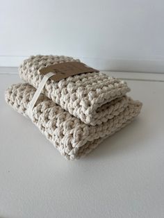 two crocheted dishcloths sitting on top of each other