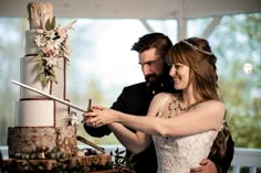 a bride and groom cutting their wedding cake