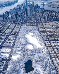 an aerial view of a large city with lots of snow and ice on the ground