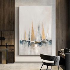 a painting hanging in a living room next to a chair