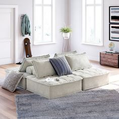 a living room filled with furniture and lots of windows