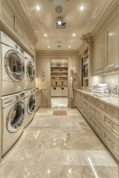 a washer and dryer are in the middle of a large room with marble flooring