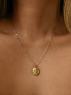 An oval locket with a floral border is placed on our 0.6mm Box Chain. Layer for effect (we recommend) or wear on its own. Always made in 100% 14k gold. Necklace Gold Locket, Gold Jewelry Locket, Gold Necklace Pendent, Dainty Gold Locket Necklace, Pendant For Necklace, Golden Locket Necklace, Real Gold Necklaces, Vintage Necklace Gold, Vintage Locket Necklace Victorian