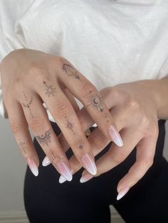 a woman's hand with tattoos on it