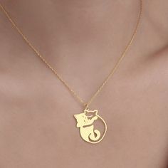 Elevate your accessory collection with the enchanting Cuddling Cats Necklace from Sussex Home. This meticulously handcrafted pendant features two entwined cats, symbolizing companionship and love, making it an ideal gift for bridesmaids, friends, or simply to treat yourself. 

- Material: Sterling Silver, Gold Plated
- Color: Gold
- Gender: Female
- Age Group: Adult

Crafted with precision in our workshop, this necklace boasts a gold-plated finish that adds a touch of elegance to any outfit. To Gold Cat Design Charm Necklace As Gift, Gold Charm Necklace With Cat Design As Gift, Gold Charm Necklace With Cat Design For Gift, Valentine's Day Gold Cat Design Jewelry, Cat Design Round Pendant Jewelry Gift, Cat Design Pendant Charm Necklaces For Gift, Cat Design Pendant Jewelry, Dainty Cat Design Necklace Gift, Mother's Day Jewelry With Cat Design For Gift