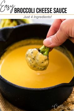 broccoli cheese sauce in a black bowl with a ladle scooping out