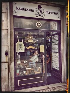 a store front with people standing in the window