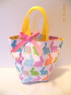 Looking for an Easter basket or gift bag, this little purse/tote will delight any little girl or toddler who likes to be just like Mommy! Perfect for taking along any essentials for a shopping trip, restaurant, off to Grandma's or the beach for the day. Plenty of room for crayons, "make up," a few little toys or whatever she might need - even a pair of pj's would fit. Can also be used as a gift bag or as a party favor. This little bag measures approx. 10 inches wide by 9 inches tall. Fully lined Cute Pink Lunch Bag For Gift, Cute Multicolor Bags For Gift, Fun Rectangular Bags For Gifts, Fun Rectangular Bags Ideal For Gifts, Fun Rectangular Gift Bags, Handmade Fun Bags For Gifts, Fun Rectangular Lunch Bag Gift, Fun Rectangular Lunch Bag For Gift, Cute Rectangular Lunch Bag For Playtime