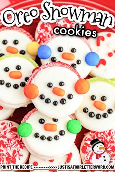 some snowman cookies are on a red plate with white frosting and black dots