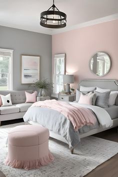 a bedroom with pink and grey decor in the corner, white bedding, gray couches