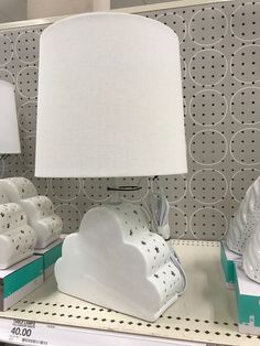 a white lamp sitting on top of a shelf