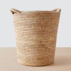 a large woven basket sitting on top of a wooden table