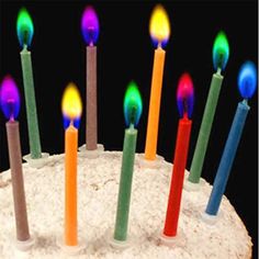 a birthday cake with multi colored candles on it