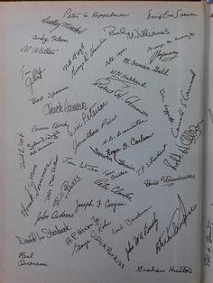 an open book with many autographs written on the pages and in different font styles