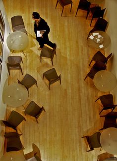 an overhead view of a person sitting in a chair and looking down at the floor