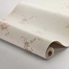 a roll of white paper with pink flowers on it