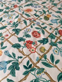 the fabric has many flowers and leaves on it