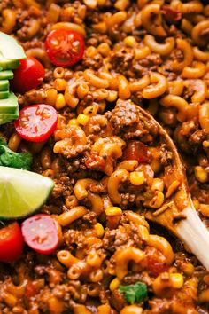 a spoon full of chili macaroni salad with tomatoes, avocado and sliced cucumbers