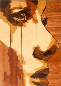 a painting of a woman's face on wood