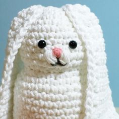 a crocheted white bunny rabbit sitting on top of a table