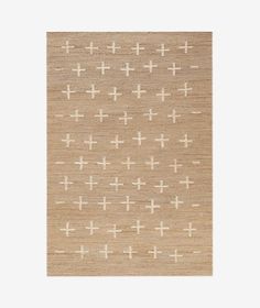 a beige rug with crosses on it