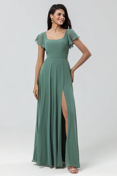 a woman in a long green dress with a slited leg and one side split