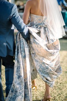 a bride and groom walking down the aisle at their outdoor wedding in an open field