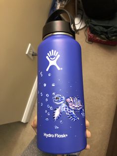 a person holding a hydro flask water bottle