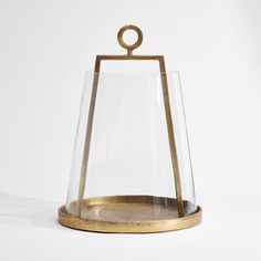 a glass and gold candle holder on a white background